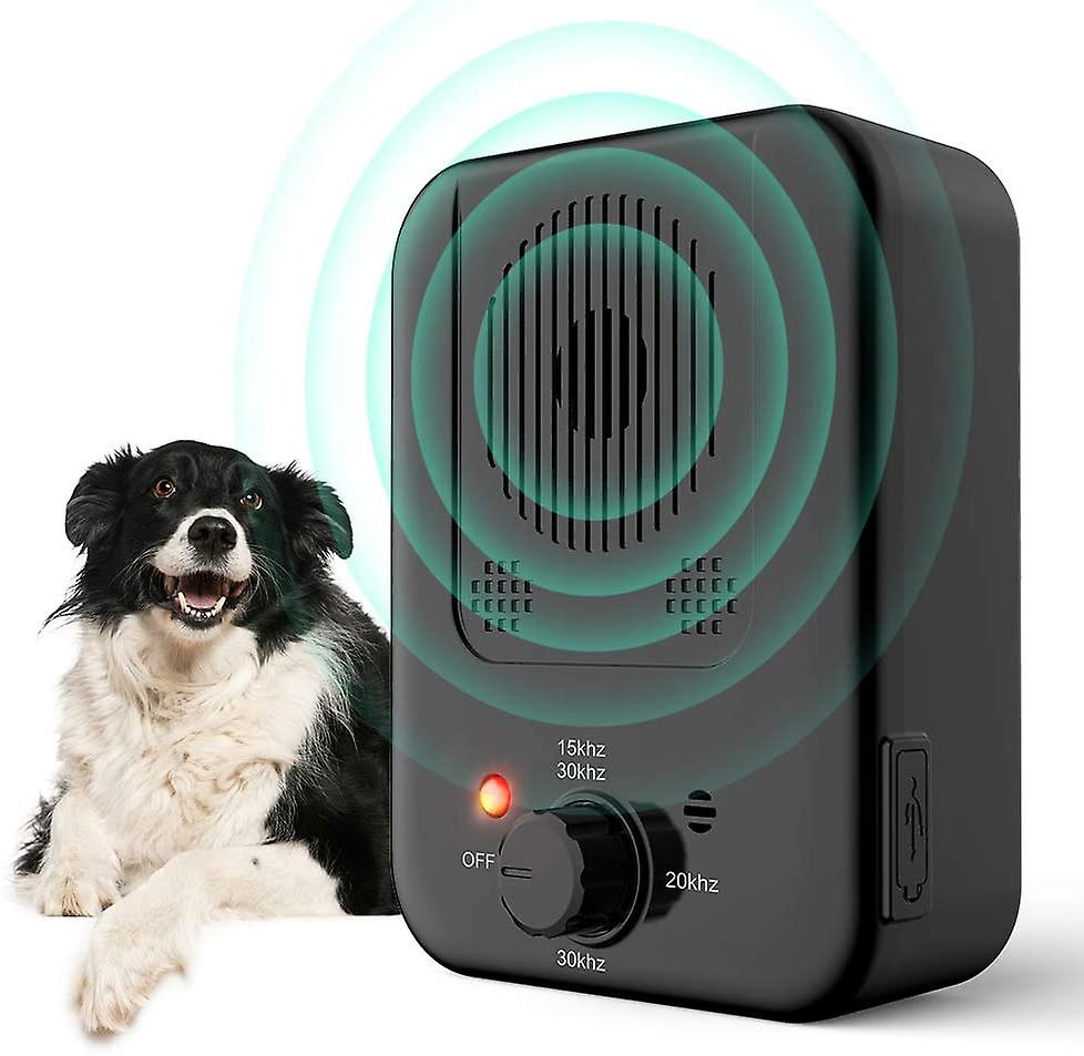 Dog sitting behind Bark Free Device 