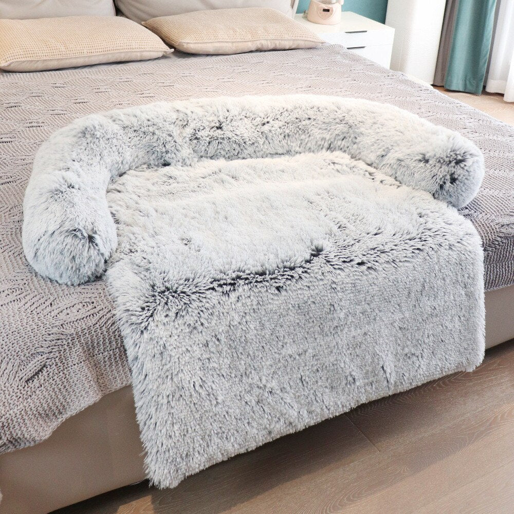 white color couch protector for dog laid down on bed 